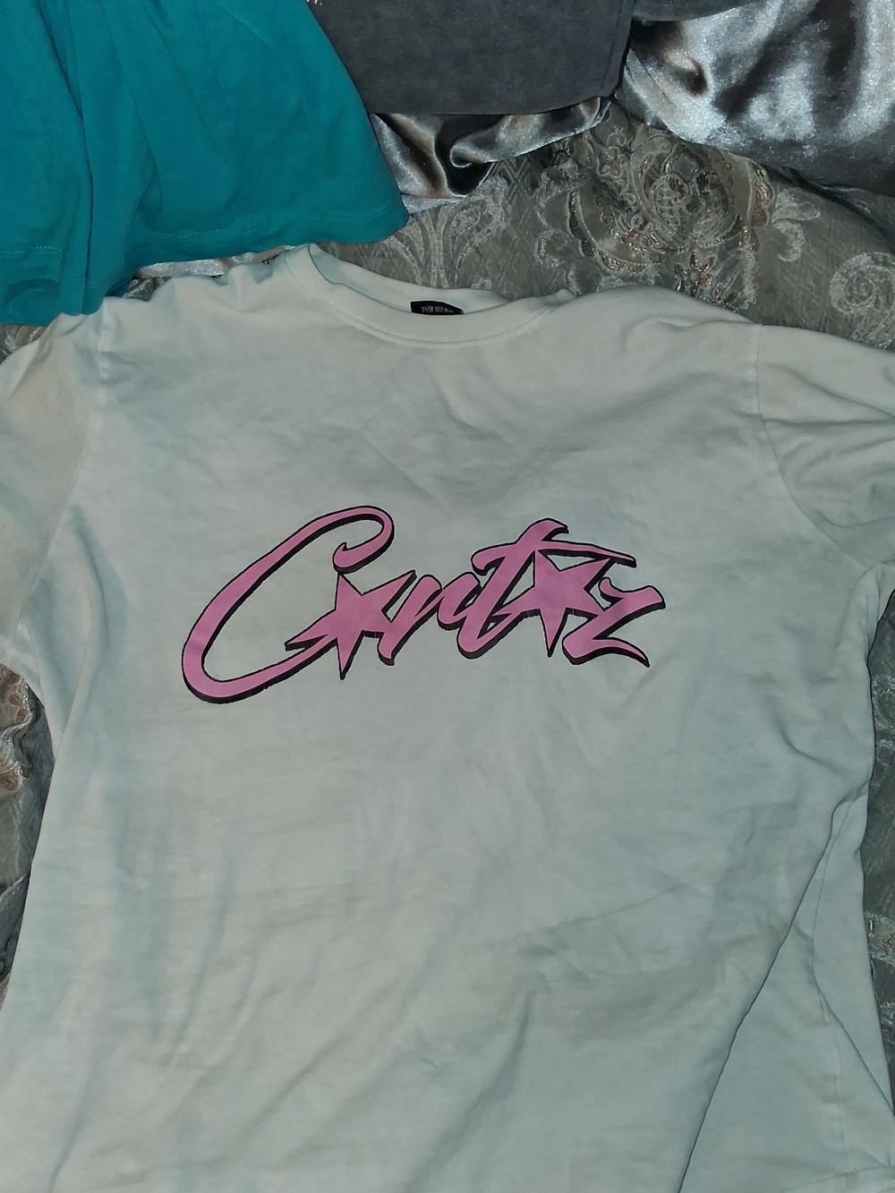 White Men’s Graphic Tee with Pink Script Logo
